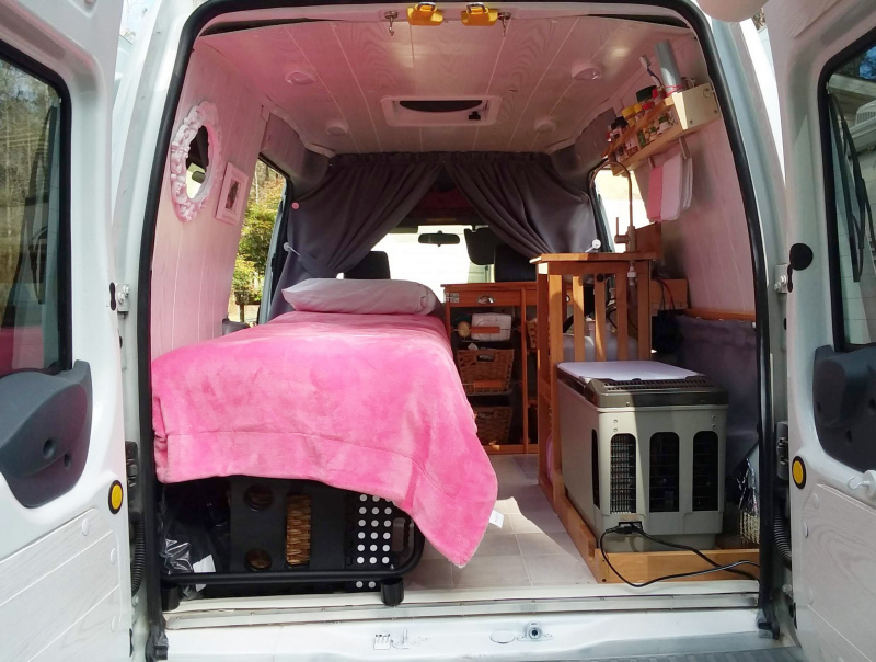 Interior view of small diy camper van from rear